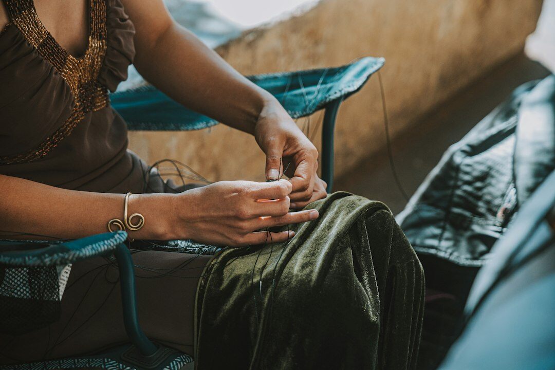 Close up of brazilian woman hands writing notes beside a laptop