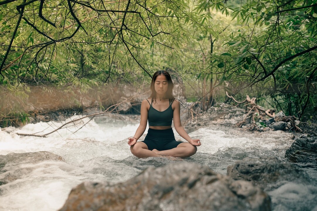person meditating in nature