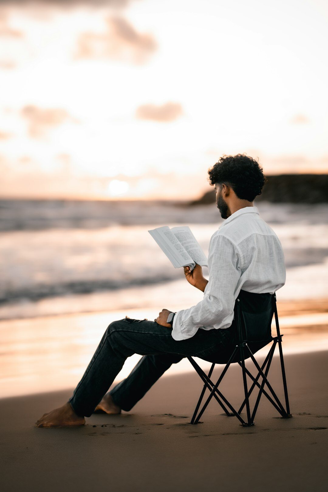 person reading book outdoors